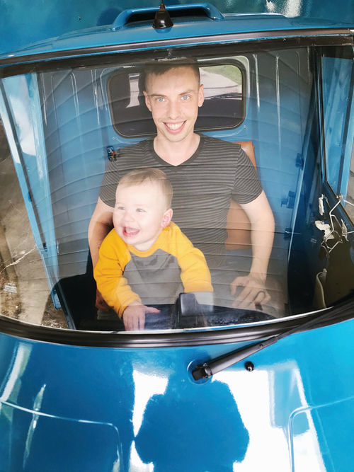 Tyler with their son, Fox, starting his Piaggio Ape driving lessons early!