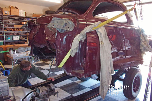 Auto body expert John Diermeirer guides the three-passenger coupe body onto the ’48 Chrysler Saratoga Eight chassis.