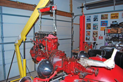 The beam on the yellow hoist could lift an MG XPAG engine nearly straight up. Note the lifting bar that was made to bolt into the holes for the valve cover studs.