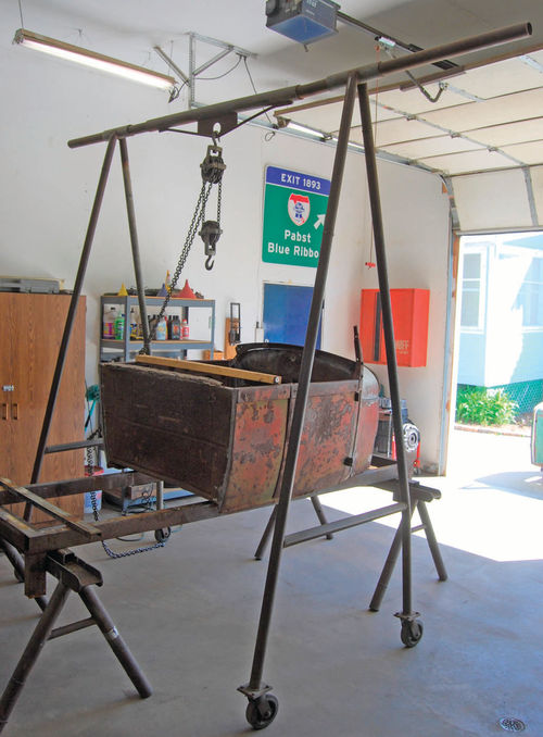 Metal fabricator and hot rodder Trent Lewis built this rolling gantry crane out of pipe. The horizontal top pipe has a large plate with a hole that the chain hoist hooks into.