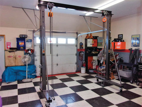 This Pittsburgh Automotive 1-ton hoist can easily be rolled around the shop and has telescoping uprights that allow it to be raised high enough to lift a car body.