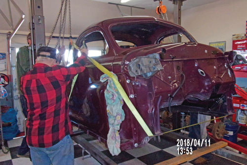 Another view of the Chrysler body drop. The body had to be lifted off the cart seen here, then dropped onto the restored chassis.