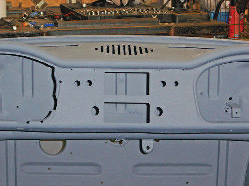 The top four round holes seen here had been cut in the dash to accommodate the switches.