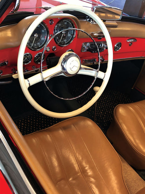 The exterior of this cherry red Mercedes is something to not be missed, but the interior is just as eye-catching! How fun would it be to drive this down the freeway on a warm summer day...