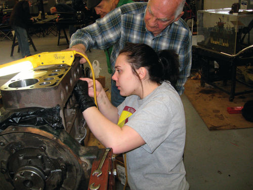 A student is learning to install adjustable lifters and valves.