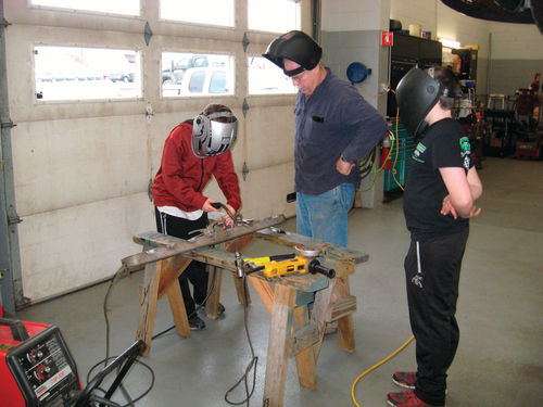 Setting up for a weld under the mentor’s watchful eye.