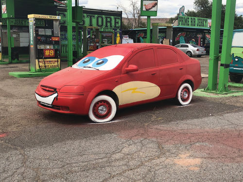 A car painted to look like Lightning McQueen from the movie “Cars.”