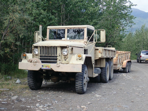 A unique truck complete with a trailer that is no doubt ready for some serious hauling and driving across the wilderness.