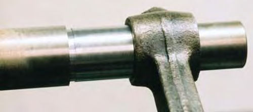 Photo 7. A piece of steel rod can be used to press out old rod bushings and press in new ones.