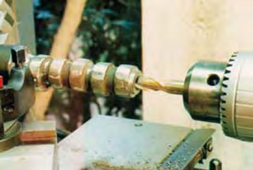 Photo 10. An old cam is center drilled to prepare it for use