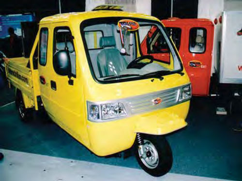 Some say that rising fuel prices will make vehicles like the 2008 Tri-Fun EXT 1/4-ton pickup the truck of the future. The optional box body can be partly seen on the red truck in the background.