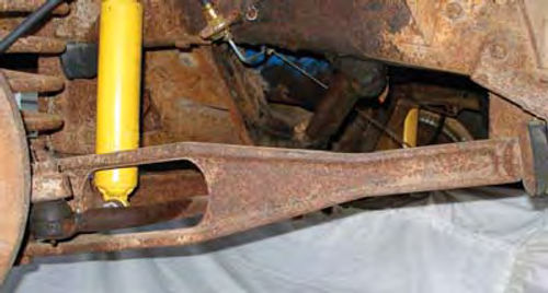 Photo 3: The radius arm, center, which is anchored to the frame (far right), braces the outer end of the I-beam front axle at my truck’s left front wheel.