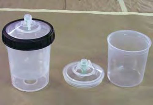 Photo 3 (right). The 3M PPS disposable cup system uses a rigid plastic container cup (on the left in the photo) and a disposable insert and lid (on the right).