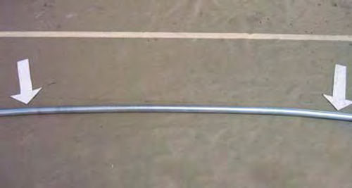 Photo 7. The stick of electrical conduit used to form the rolled edge for the top is slightly curved.