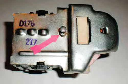 Photo 13. The red arrow on the bottom of the switch points to the release button for knob removal.