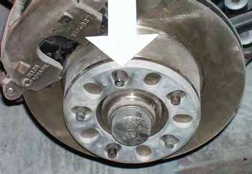 A wheel shim, known as a “spacer” in racing circles, will move the wheel outboard enough to clear the calipers.