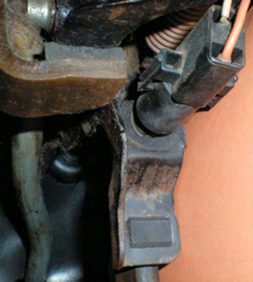 Photo 27. A typical mechanical brake light switch, mounted near the top of the brake pedal.