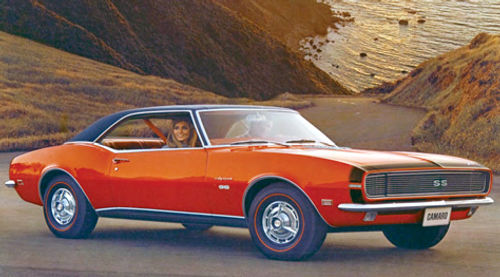 Judging by the happy look on this young woman’s face and the clean pavement under the car, perhaps she’s pleased that her ’68 Camaro Rally Sport SS isn’t leaking fluids that could harm the shimmering body of water in the background.