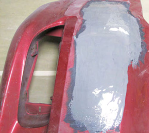 Photo 7. The outside of the bumper is coated with 3M EZ Sand to help smooth out the damaged areas.