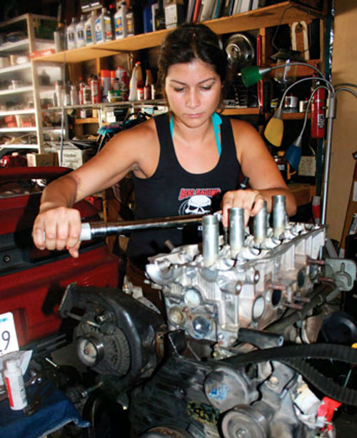 After cleaning the head bolt threads, Renata is seen using her “totally sweet Snap-On torque wrench” to install and torque the bolts to spec