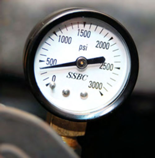 Photo 6. A pressure gauge was threaded into the bleeder port of one front caliper (shown) and one rear wheel cylinder to measure the brake pressures in each circuit. This allowed for a quick focus on the problems.