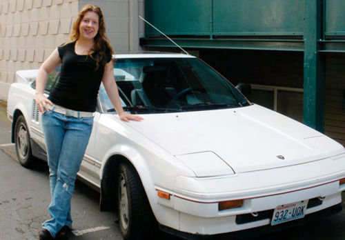Ragina with the 1986 MR2 that she lost once but recently regained as a birthday gift.