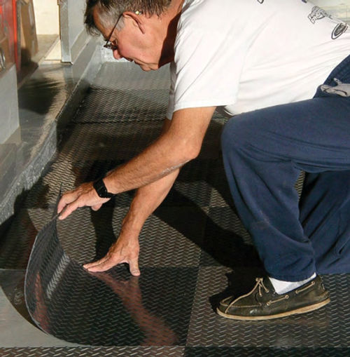 The author easily installs one of the tiles along a relatively straight edge of his garage.