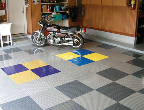 The monochromatic tone of the tile work is livened up with the addition of blocks of school colors representing the two colleges attended by the author’s sons.