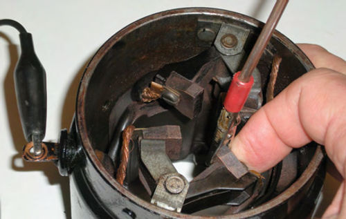 Photo 14. While testing the field coils for an open circuit, move the insulated brush holder with your finger.
