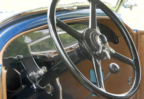 Brightwork and the body-color cowl contrast nicely with the mostly black dashboard and its hint of art deco design.