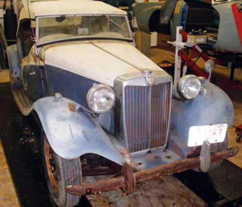 Although the “barn find” TD is rough, the fenders and grille appear to be nicer than those on the red car.