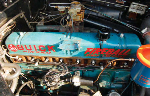 The valve cover still has original paint and lettering, but that black spill no doubt is newer, perhaps from a garage accident. The plug wires are of an older style and probably are the originals.