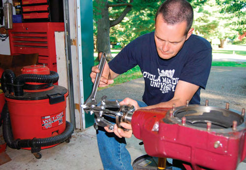 A puller was used to remove the original TD pinion flange from the red car’s axle.