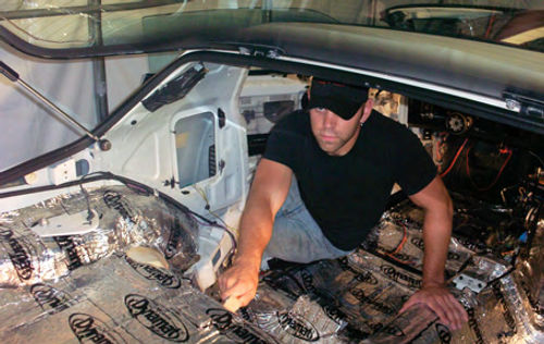 Here I am finishing up the Dynamat sound proofing installation in the Camaro. You can see just how far down I took the interior to make sure no detail was left out.