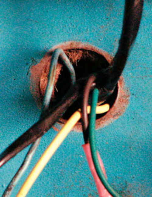 Photo 3. Always use grommets where wiring passes through the body to protect the wires and keep fumes out. The situation shown here is a short circuit waiting to happen.