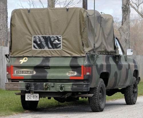 In a rear view, the high covered cargo area makes the M1008 seem larger than it really is.