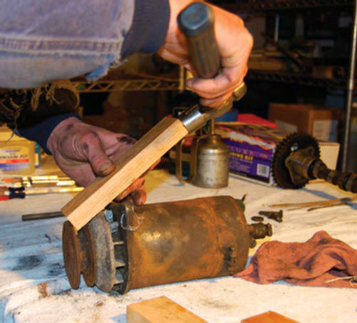 The blue “hot rod’s” generator was ugly, but had better internals. A block of wood and hammer were used to remove the “dished”-style fan and the pulley. The blue car’s generator is going to need cleaning,