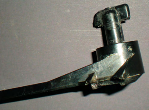 Photo 3. The broken lever is shown here with the bottom side up. The “T-type” end is what retained it.