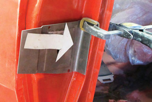 Photo 3. The inside edge of the new plate is bent to 90 degrees before fitting it to the door jamb opening.