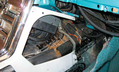 Photo 2. It was necessary to remove the side cover from the center console as well as the lower dash panel below the glove box from this 1965 Thunderbird to access the back of the radio and run the wiring to the fuse box.