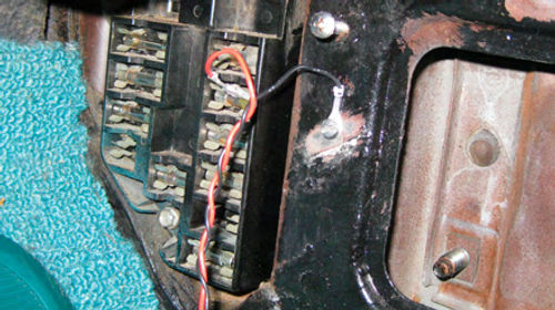 Photo 3. The fuse box is located behind the passenger side kick panel below the dash on this particular car.