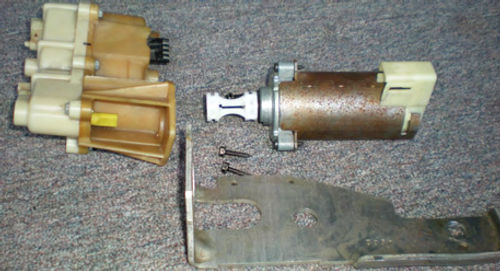 Photo 15. Three screws hold the motor and transmission. Note the coupler on the motor’s shaft.