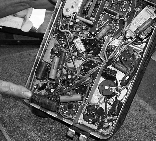 Those little paper and wax cylinders are condensers (left). They need to be replaced with much more reliable capacitors. An easy test for tubes is to tap them with a pencil eraser. If they buzz, squeal or howl, they need replacing.