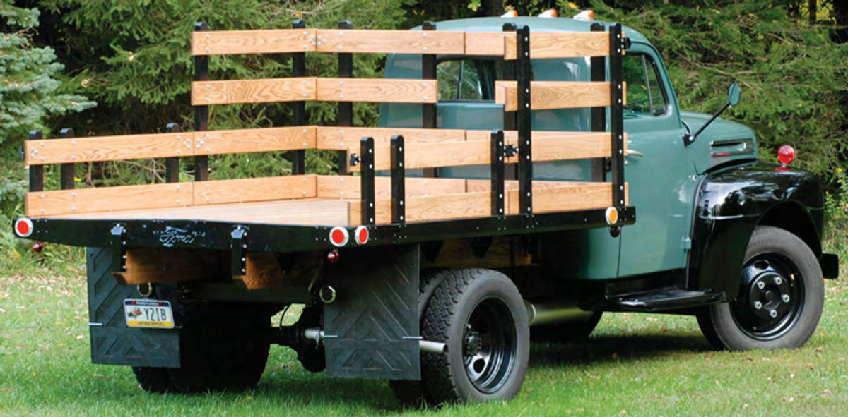 Ford boasted that its bodies were “designed and built to carry great bulk and a great variety of merchandise.” And in this case, black fenders and a simple round mirror on a long arm mark the Ford as a straightforward truck ready for business.