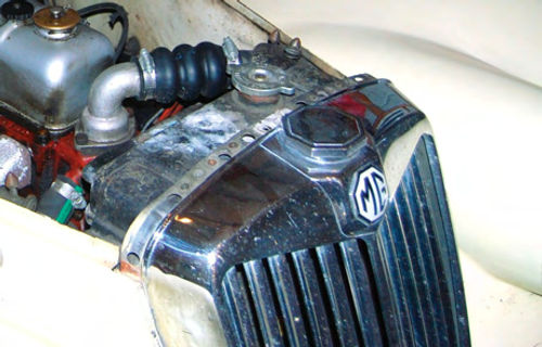 The correct radiator hose for an MG TF is designed to “accordion” so that it can be installed in a small gap. This is a new one sourced from Moss Motors.