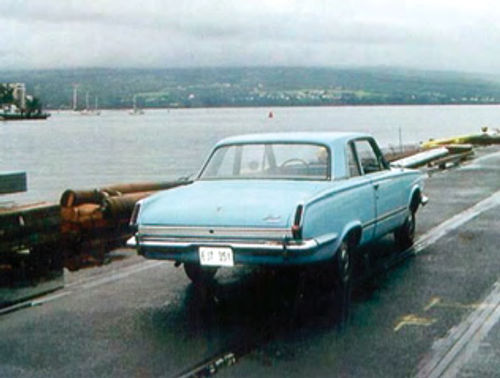 The fifth car in the collection, a 1964 Valiant, arrives in Hilo from Honolulu