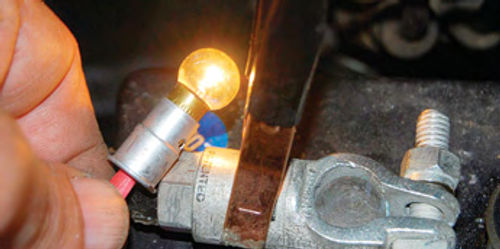 Bulb operation was tested by holding the wire against the positive post of another 6-volt battery and grounding the bulb holder to a negative connector.
