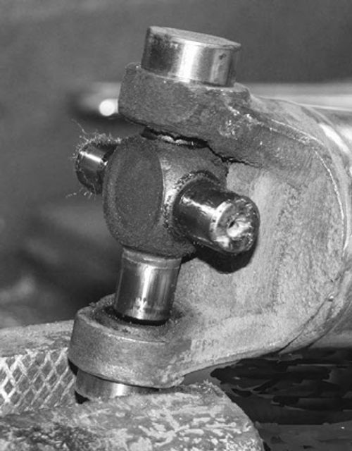 Lift out the steel cross and work the final bearing cap loose using the vise.