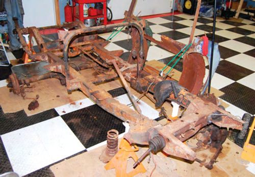 Visitors to the shop where the MG TD hot rod is being worked on saw this rusty frame and chassis when they stopped in a year ago. It was a mess and if you could “zoom” this photo, you’d see several huge holes in the frame rails.