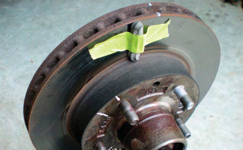 Photo 8. Masking tape secures a wheel weight in position on the light spot of the rotor for testing.